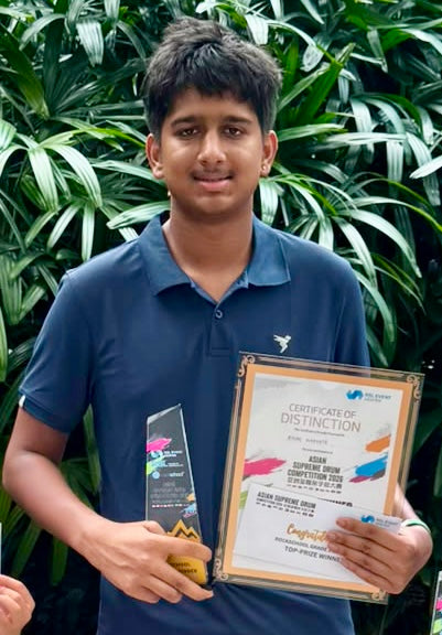 Ayush Nakhate holding Top Prize Winner Certificate of Distinction and trophy for Grade 3 after winning Gold at Asian Supreme Drum Competition ASDC 2026 Singapore on 8th August 2026